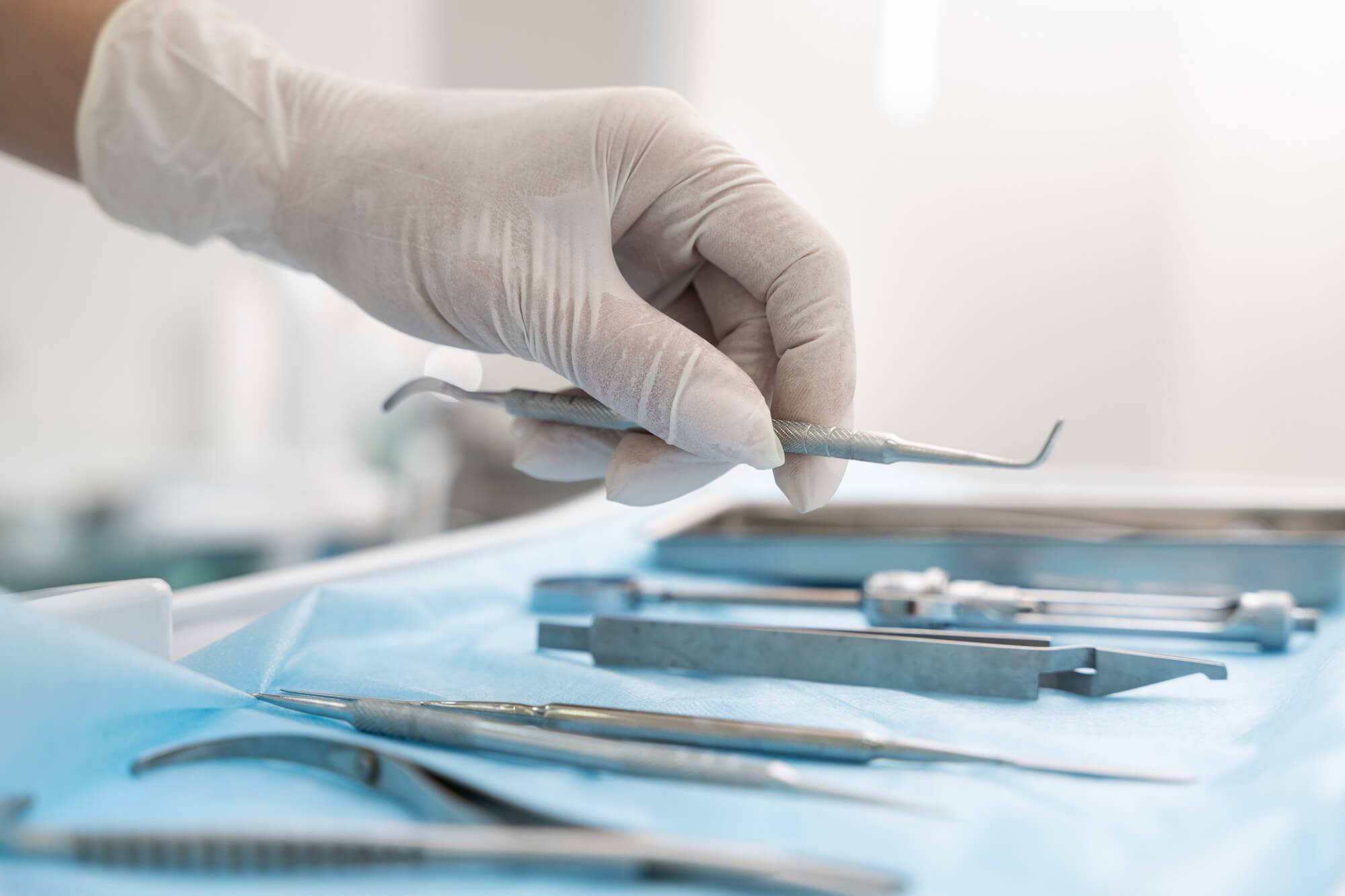 dentist-picking-up-utensil-teeth